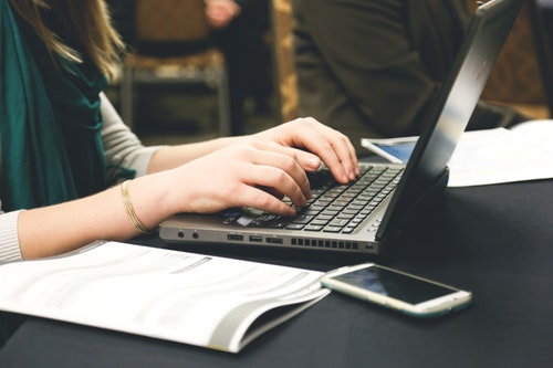 Woman Typing on Laptop Sending Emails